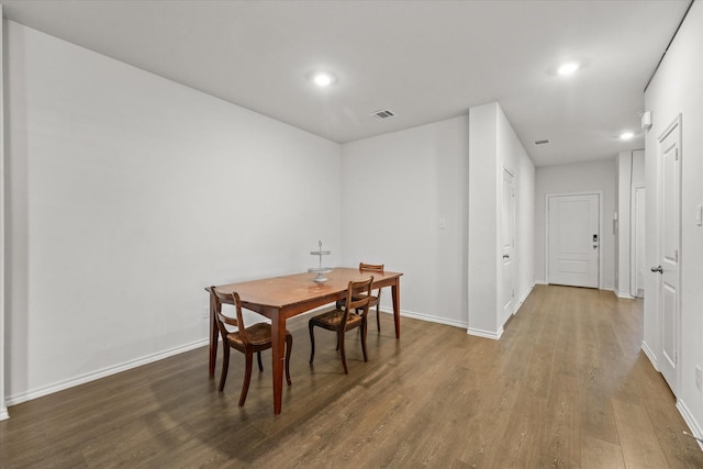 dining space with dark wood-type flooring