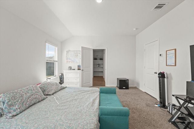 carpeted bedroom featuring lofted ceiling