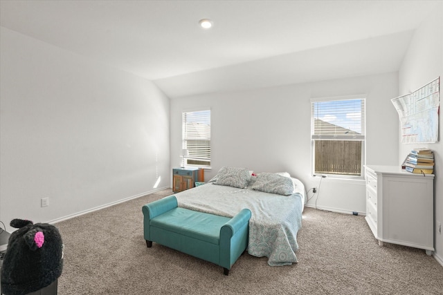 bedroom with vaulted ceiling and carpet floors