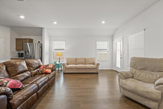 living room featuring dark hardwood / wood-style flooring and lofted ceiling