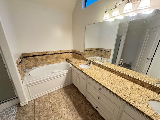 bathroom with vanity, tile patterned floors, and a bath