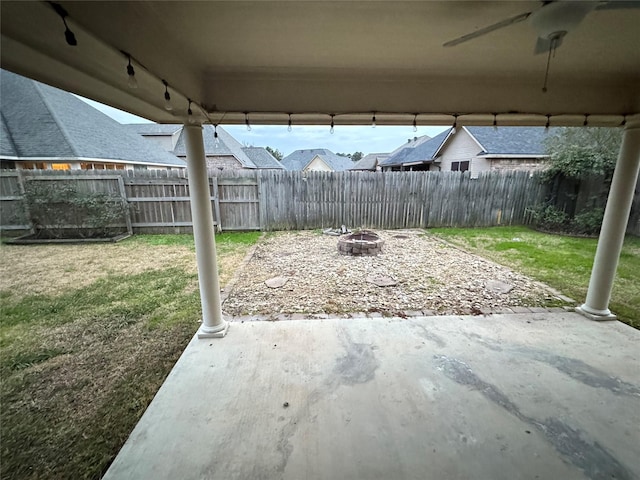 view of patio / terrace with ceiling fan and a fire pit