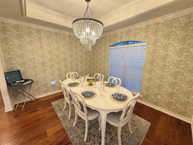 dining area featuring a tray ceiling, dark hardwood / wood-style floors, crown molding, and a notable chandelier