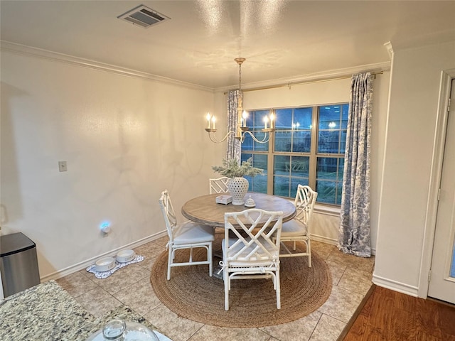 dining space with a notable chandelier and crown molding