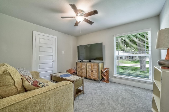 carpeted living room with ceiling fan