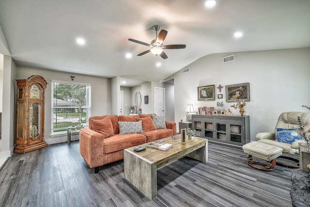 living room with ceiling fan, vaulted ceiling, and dark hardwood / wood-style floors