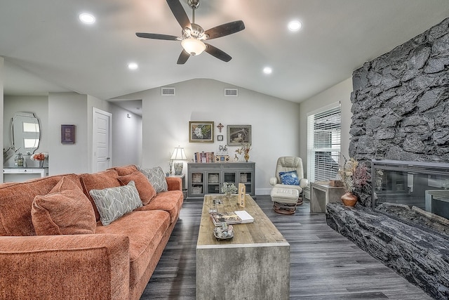 living room featuring a fireplace, vaulted ceiling, dark hardwood / wood-style flooring, and ceiling fan