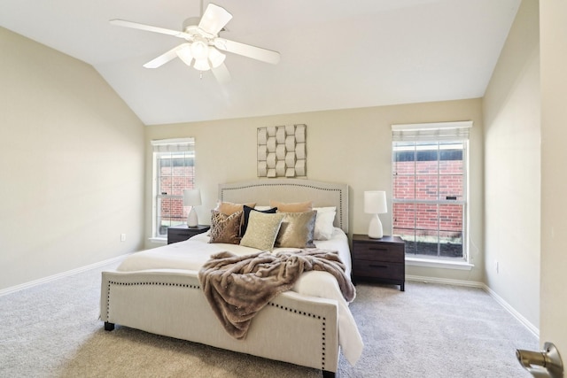 bedroom with ceiling fan, light colored carpet, and vaulted ceiling