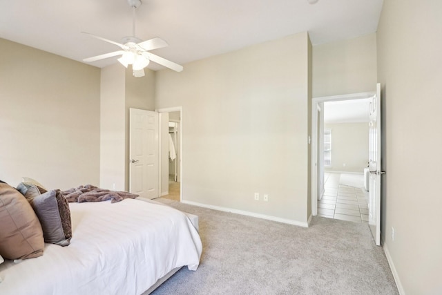 bedroom with ceiling fan and light carpet