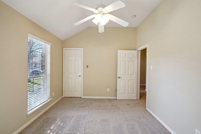 unfurnished bedroom featuring ceiling fan, light carpet, and lofted ceiling