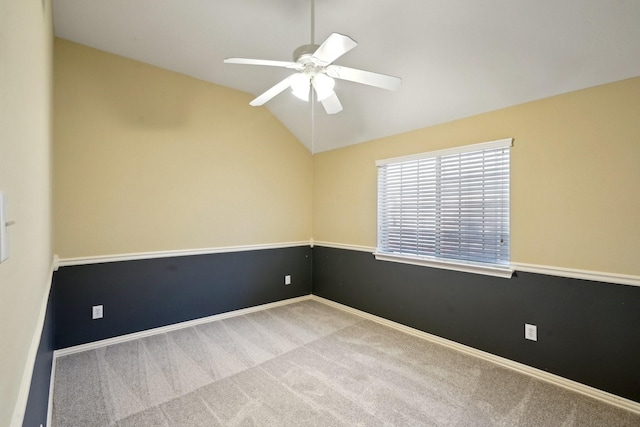 carpeted spare room featuring ceiling fan and lofted ceiling