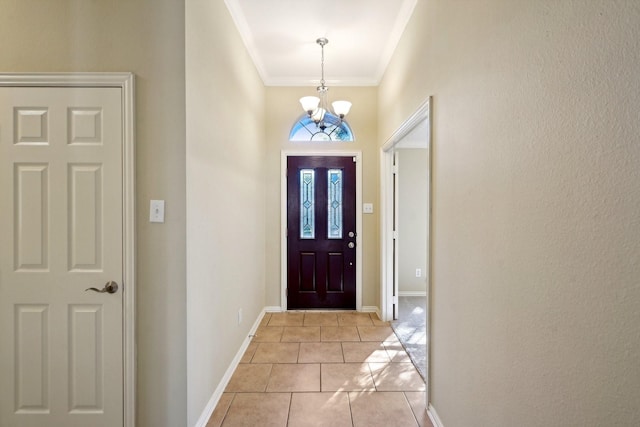 foyer with light tile patterned floors, a chandelier, and ornamental molding