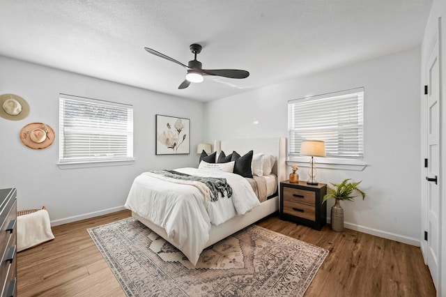 bedroom with hardwood / wood-style floors and ceiling fan