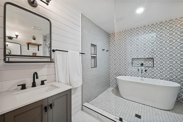 bathroom with a tub to relax in and vanity