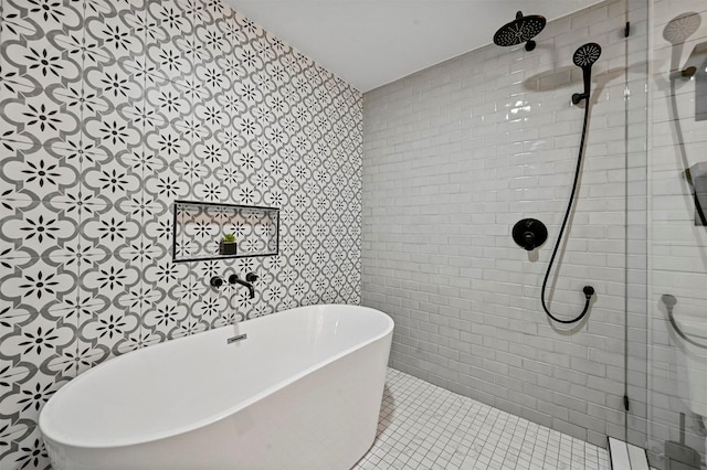 bathroom with tile patterned floors and shower with separate bathtub