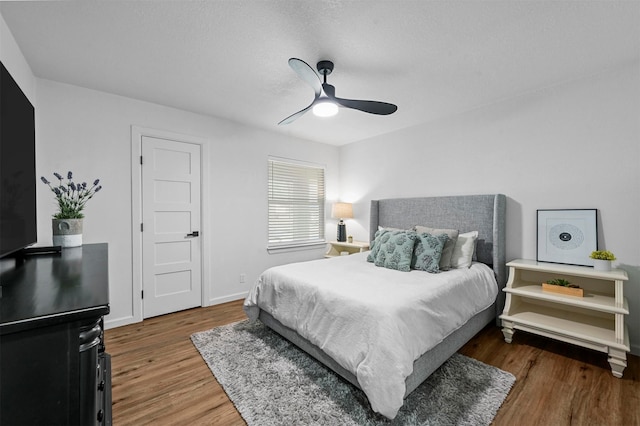 bedroom featuring ceiling fan and dark hardwood / wood-style flooring