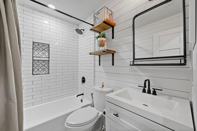 full bathroom with vanity, tiled shower / bath combo, toilet, and wood walls