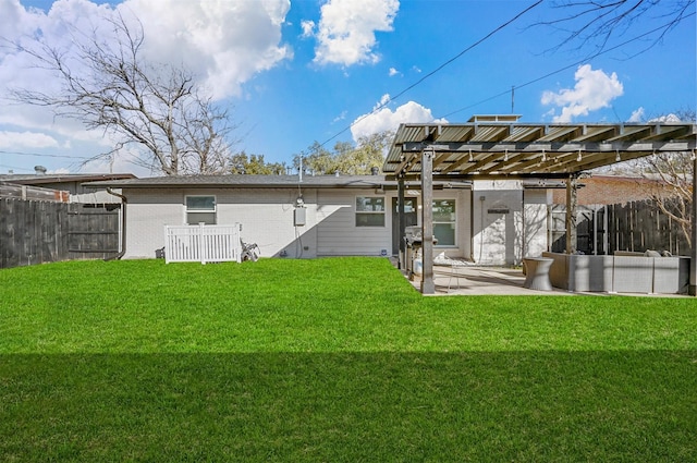 back of property with a patio, a yard, and a pergola