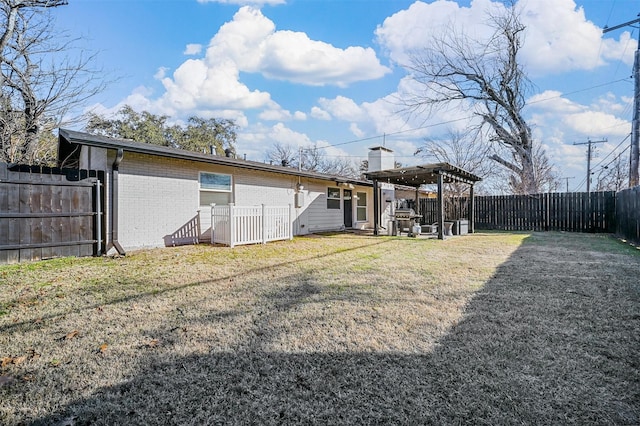 rear view of property with a lawn