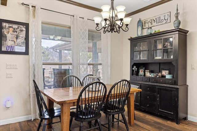 dining space with dark wood-type flooring, a chandelier, and ornamental molding