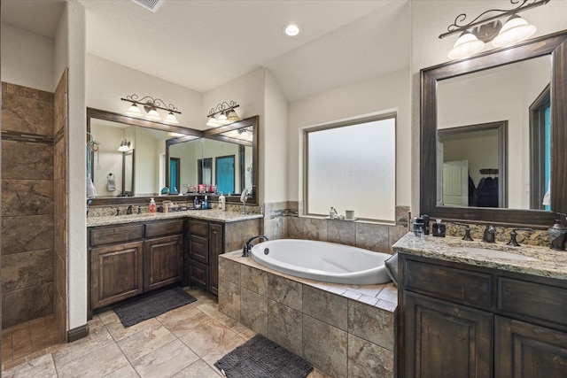 bathroom with separate shower and tub and vanity