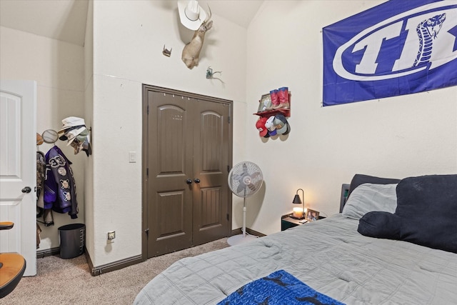 bedroom with lofted ceiling and light carpet