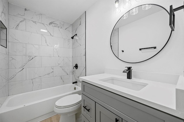 full bathroom with toilet, tiled shower / bath, and vanity