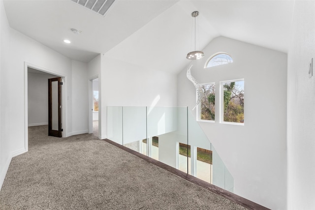 corridor with high vaulted ceiling and carpet