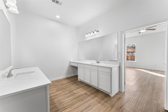 bathroom with vanity, hardwood / wood-style floors, and ceiling fan