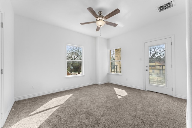 spare room featuring ceiling fan and carpet flooring