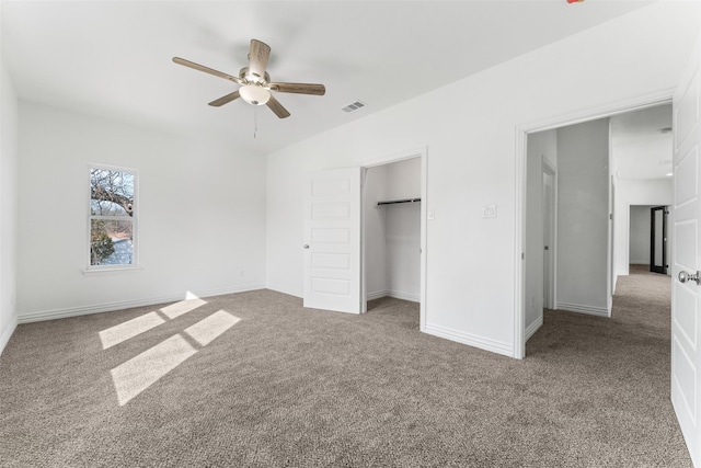 unfurnished bedroom with ceiling fan, carpet flooring, and a closet