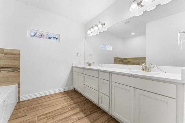 bathroom with vanity and a tub to relax in