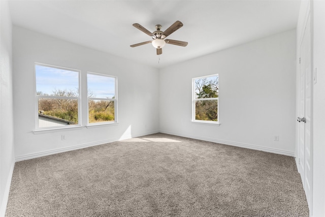 carpeted spare room with ceiling fan