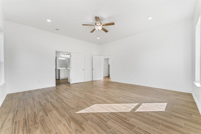 unfurnished bedroom with ceiling fan, connected bathroom, and light hardwood / wood-style floors