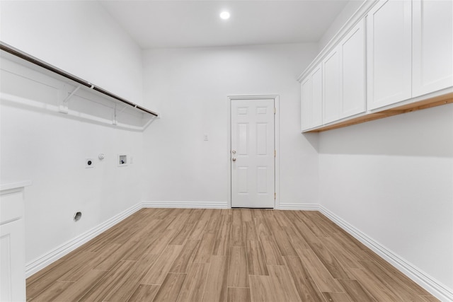 laundry room with cabinets, hookup for a gas dryer, hookup for a washing machine, hookup for an electric dryer, and light wood-type flooring