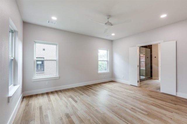 spare room featuring ceiling fan and light hardwood / wood-style floors