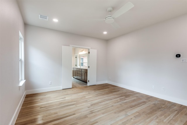 unfurnished room featuring ceiling fan, light hardwood / wood-style floors, and sink