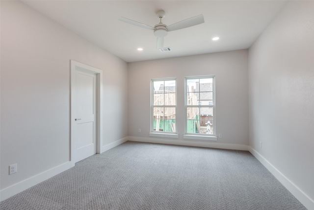 carpeted spare room featuring ceiling fan