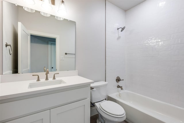 full bathroom with toilet, tiled shower / bath, and vanity