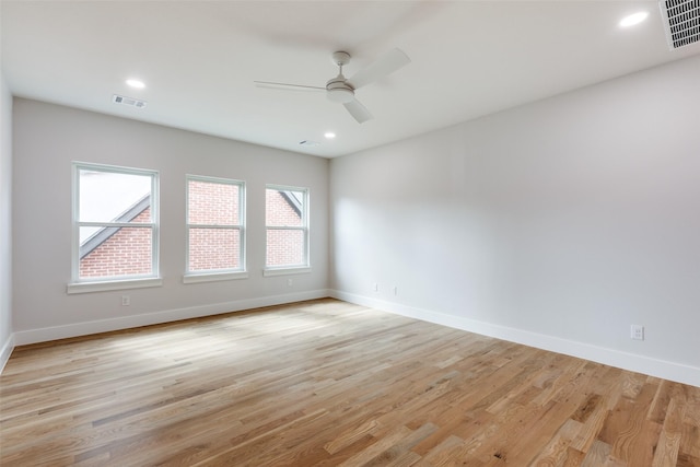 spare room featuring ceiling fan and light hardwood / wood-style flooring