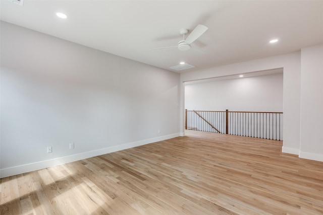 spare room with ceiling fan and light wood-type flooring