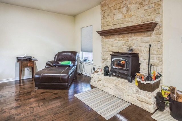 living room featuring dark hardwood / wood-style floors and a wood stove