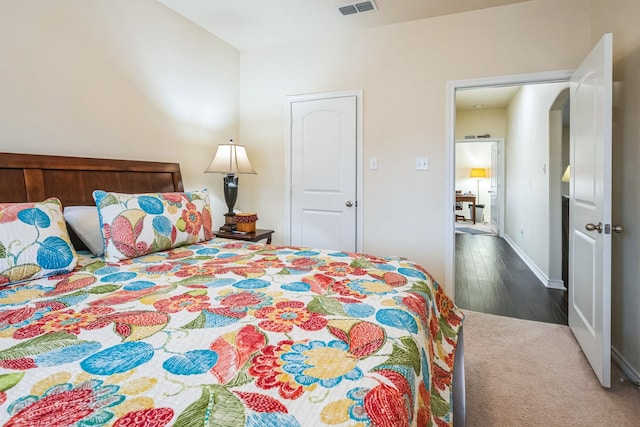 bedroom with dark wood-type flooring