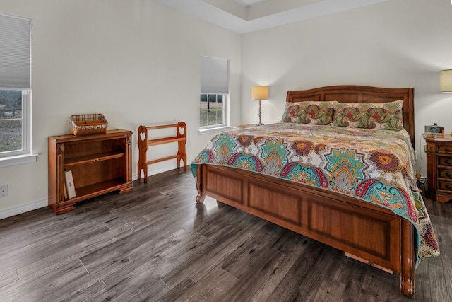 bedroom with dark wood-type flooring