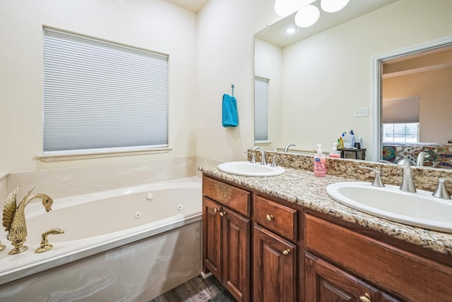 bathroom with vanity and a bath