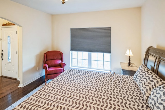 bedroom with dark wood-type flooring