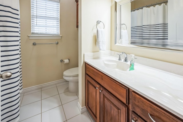 bathroom featuring toilet, vanity, and tile patterned flooring