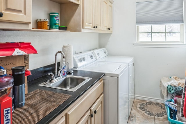 laundry area with light tile patterned flooring, cabinets, washer and dryer, and sink