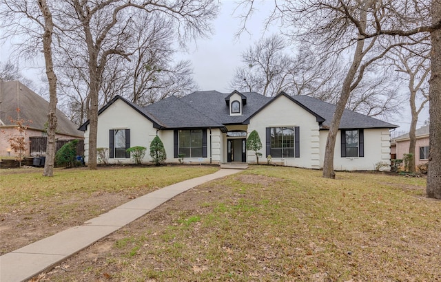 french country inspired facade featuring a front yard