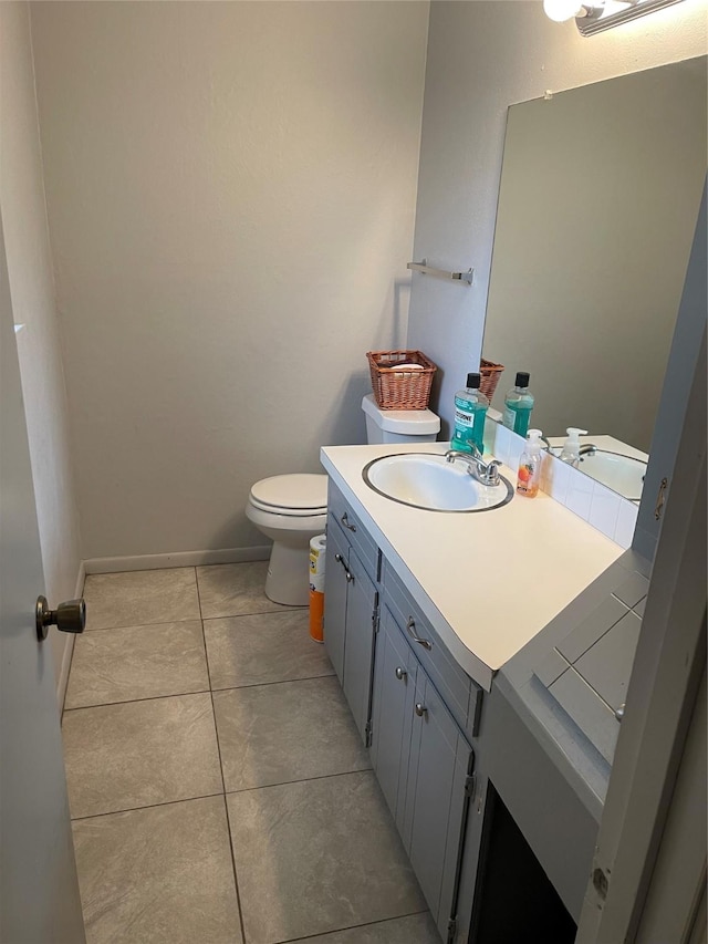 bathroom featuring toilet, vanity, and tile patterned flooring